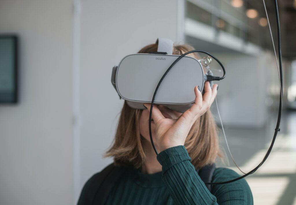 Close-up photograph of a woman using a VR headset.